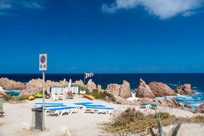 Scenic view of beach against blue sky