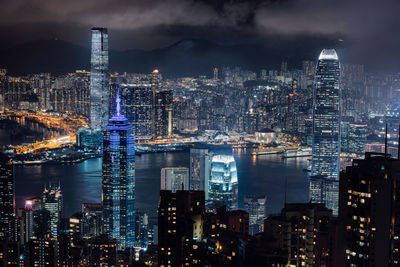 Illuminated cityscape against sky at night