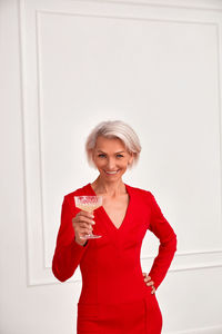 Content mature woman with glass of champagne