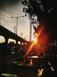 Traffic on road at sunset