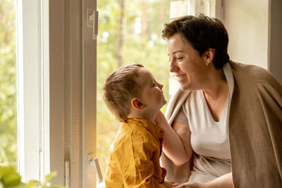 Happy grandmother and grandson enjoy time together. positive middle age woman 