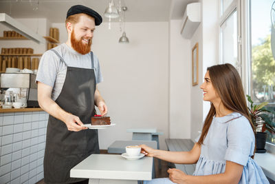 Young couple holding food at home