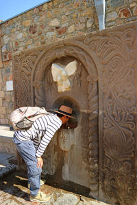 Full length of man standing by historic building