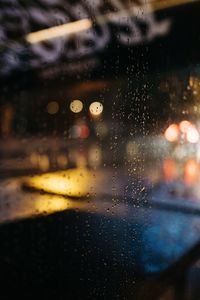 Close-up of wet glass window in rainy season