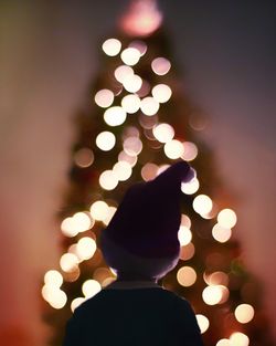 Close-up of hand holding illuminated christmas tree