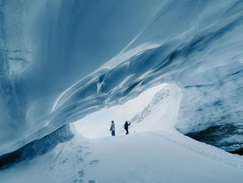 People in ice snowcapped cave