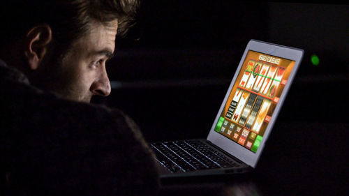 Close-up of man playing game in laptop