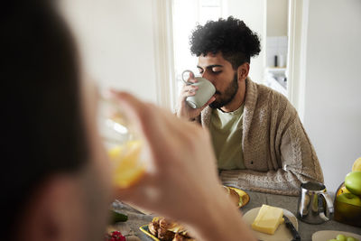 Man at table having coffee during breakfast