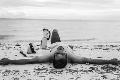 People on beach against sky