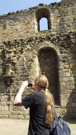 Man photographing kirkstall abbey