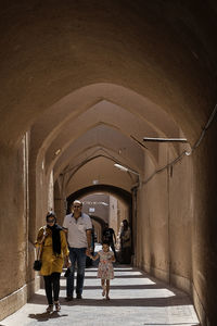 Rear view of people walking in corridor