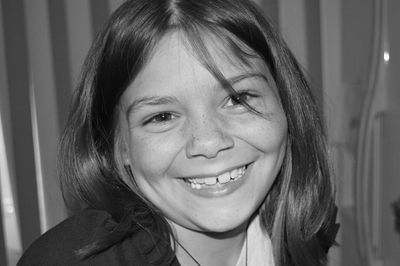 Close-up portrait of a smiling young woman