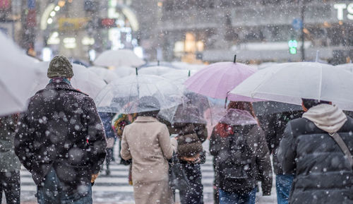 People walking on wet street in rain