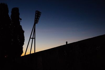 Low angle view of silhouette bridge against sky at sunset