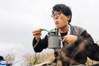 Portrait of man eating outdoors