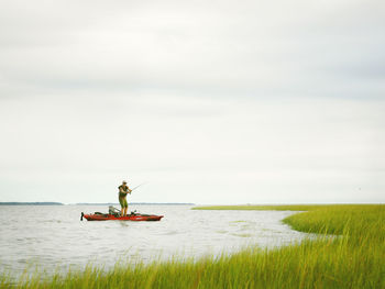Fly fishing a marsh on the atlantic coast from a kayak.