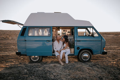 Vintage car on land against sky