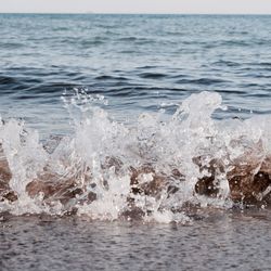 Close-up of wave in sea against sky