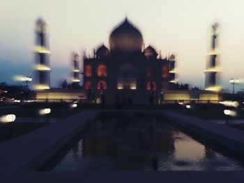 Reflection of illuminated buildings in city at night