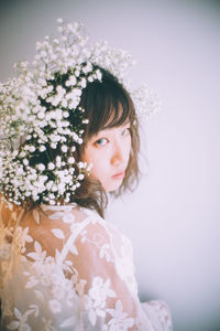 Close-up of woman wearing white flowers