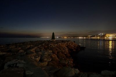 Scenic view of sea against clear sky at night