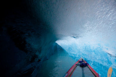 Cropped image of boat on sea in ice cave