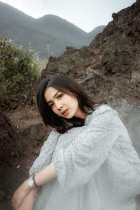 Portrait of smiling young woman in mountains