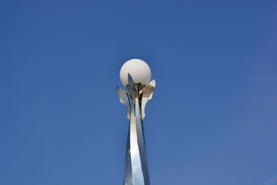 Low angle view of lamp post against blue sky