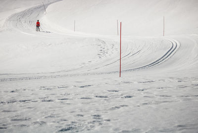 View of people skiing on snow covered land