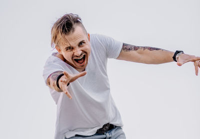 Portrait of smiling man standing against white background