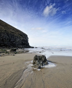 Rocks on beach against sky