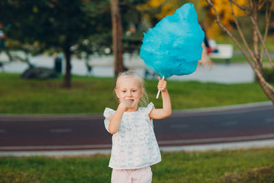 Portrait of girl holding plant