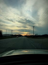 Road against sky seen through car windshield