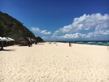 Scenic view of beach against blue sky