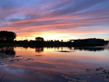 Scenic view of lake against orange sky