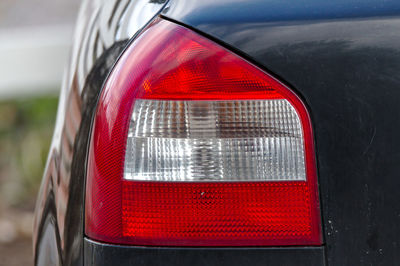 Close-up of red car on road