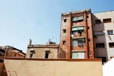 Low angle view of residential buildings against blue sky