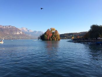 Scenic view of lake and mountains against clear sky