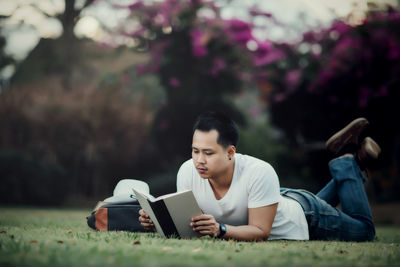 Man using mobile phone while sitting outdoors