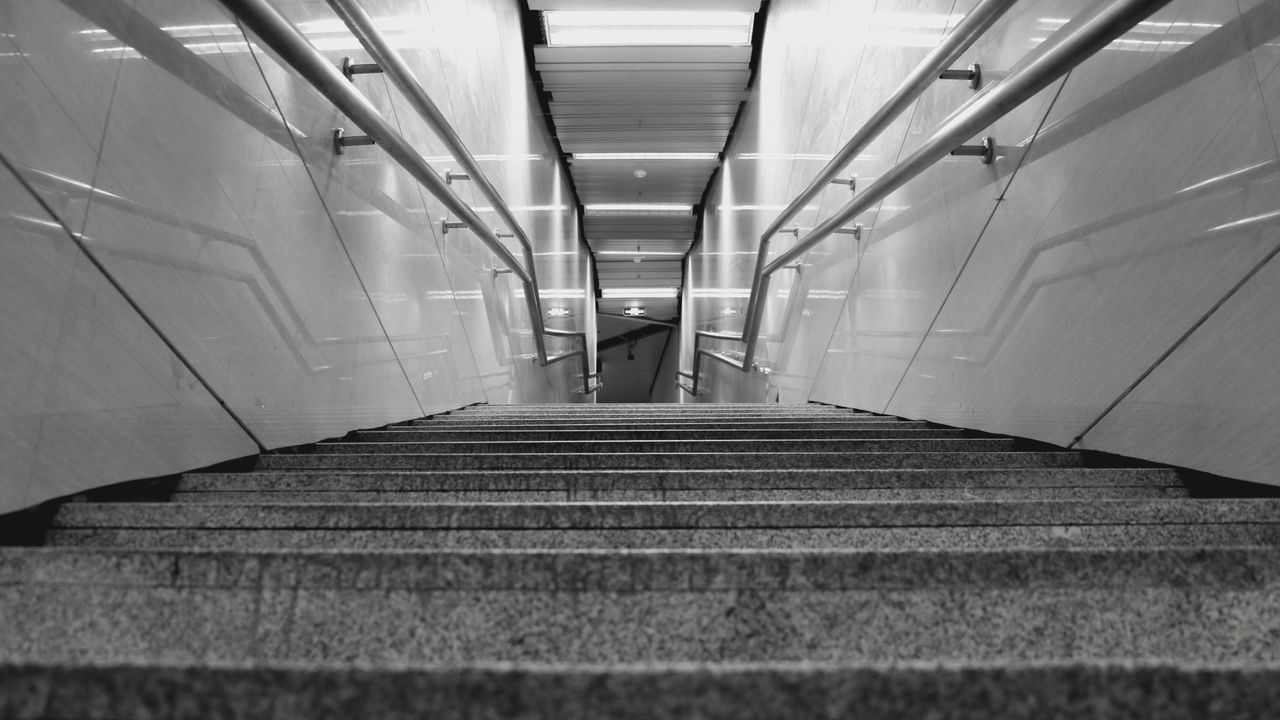 indoors, steps, steps and staircases, staircase, the way forward, architecture, built structure, railing, escalator, ceiling, diminishing perspective, stairs, corridor, low angle view, building, subway, wall - building feature, empty, high angle view, modern