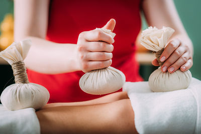 Kizhi massage or herbal bolus bags ayurveda massage, hands of an ayurveda massage 