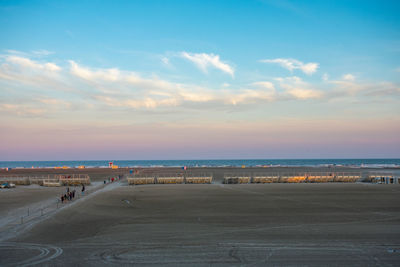 Scenic view of beach against sky during sunset