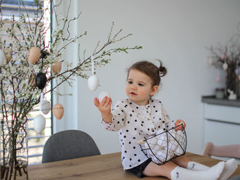 Portrait of cute girl playing with christmas tree