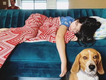 Portrait of woman with dog relaxing at home