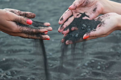 Close-up of man holding water in lake