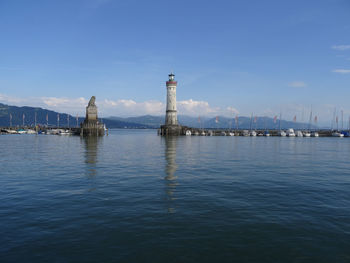 Sailboats in sea against sky