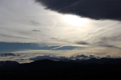 Low angle view of silhouette mountains against sky at sunset