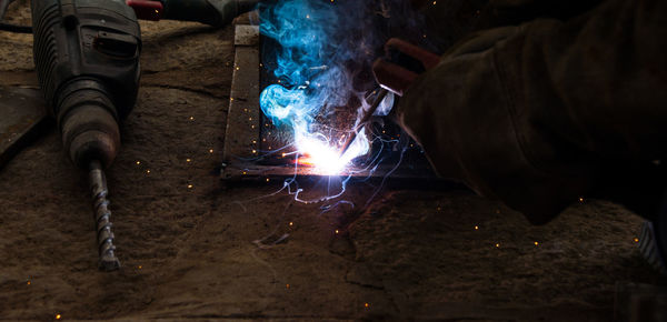 Cropped image of welder working at workshop