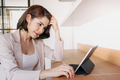 Young woman using laptop at home