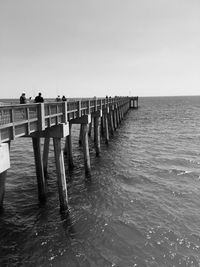 Wooden posts in sea